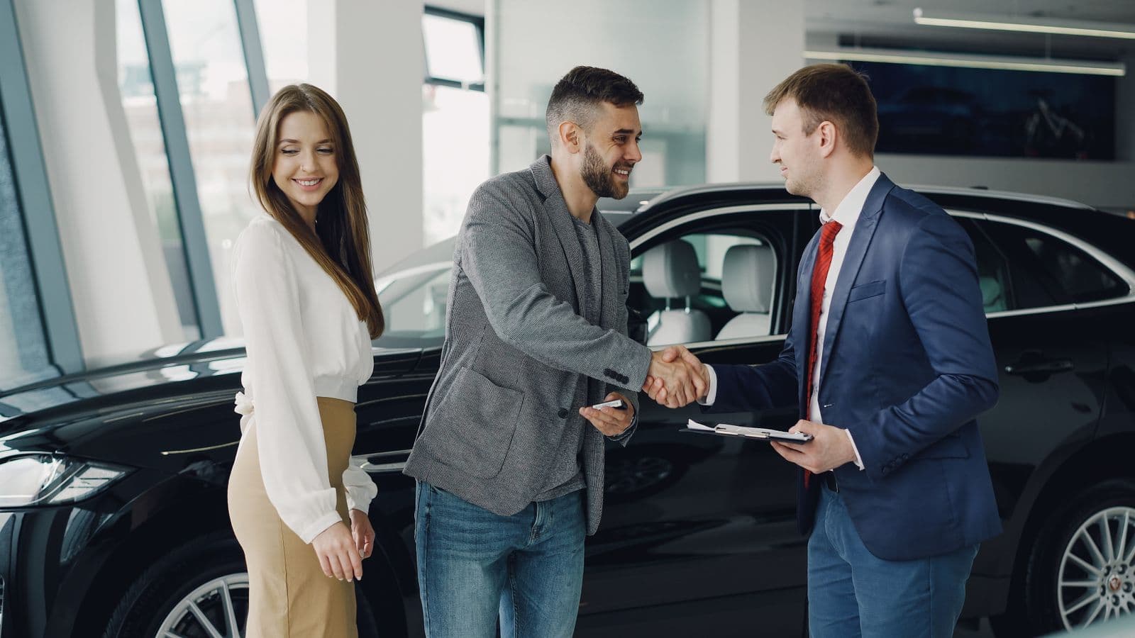 Dealer and customer shaking hands in the showroom