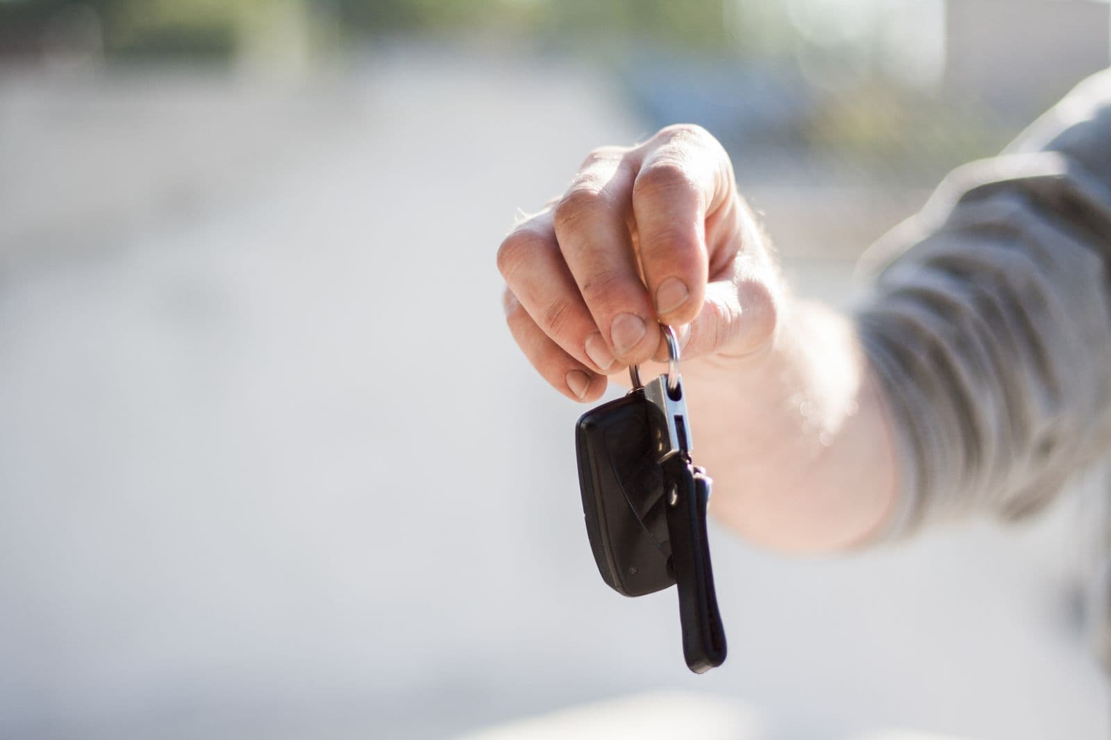 Salesperson handing over car keys to a customer
