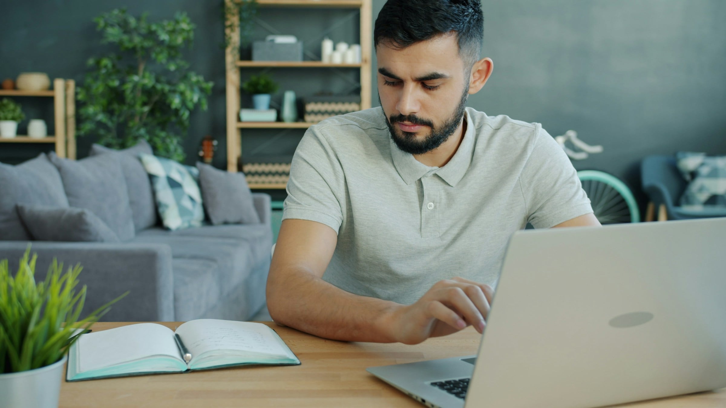 Man at home answering questions on his laptop